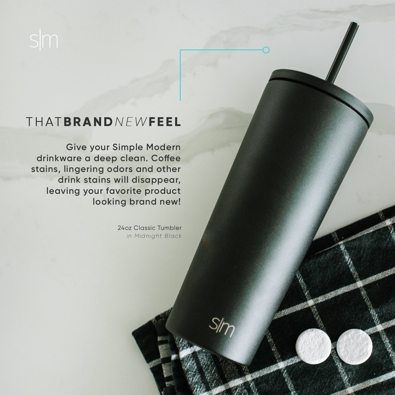 Matte black tumbler with charcoal gunmetal finish on soft gray and off-white marble-textured background