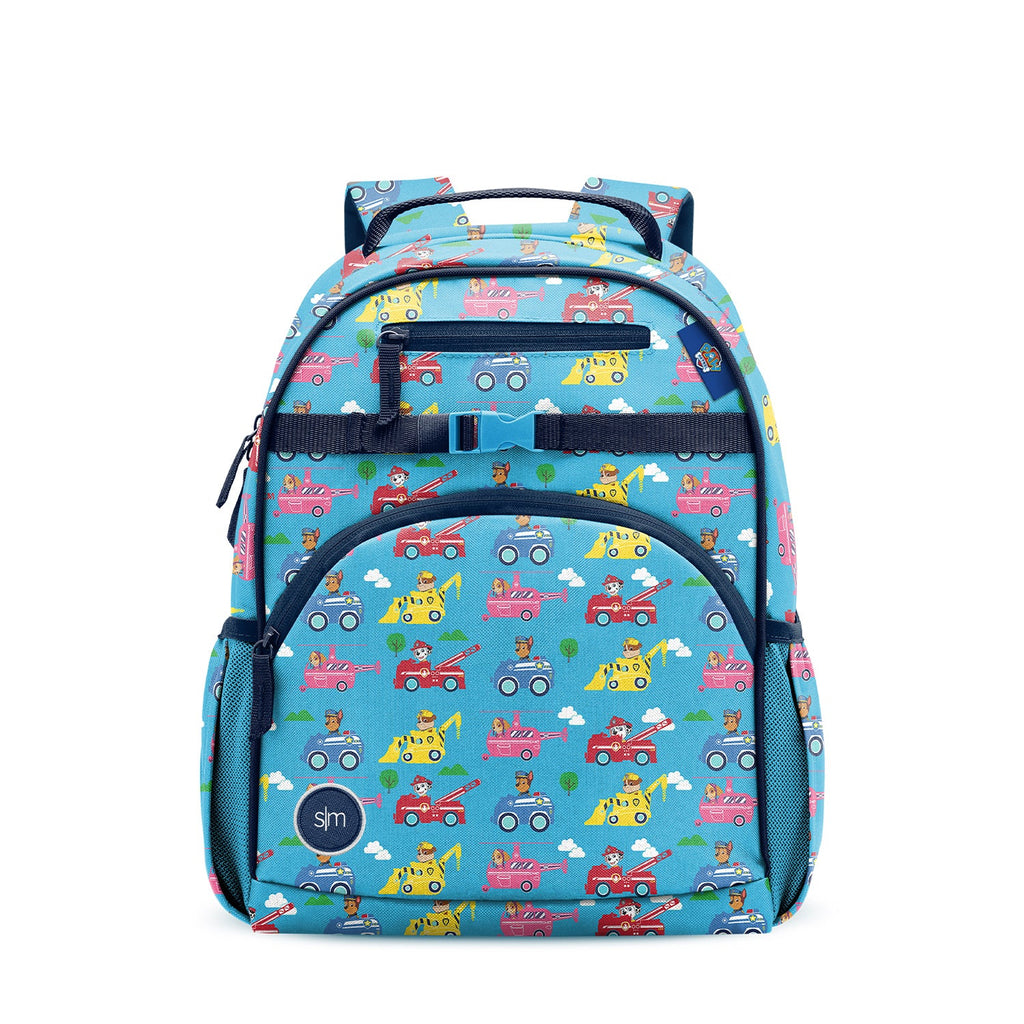 Turquoise children's backpack with colorful vehicle print featuring fire trucks, construction vehicles, and police cars. Navy straps, mesh pockets, and Simple Modern logo patch. Studio product photo on white background.