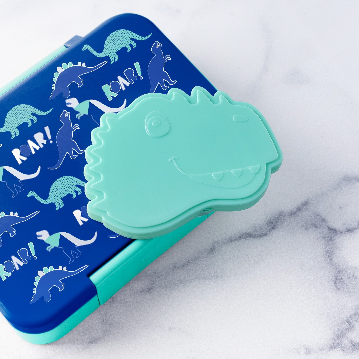 Blue and mint green children's dinosaur-themed lunch container with matching lid and handle