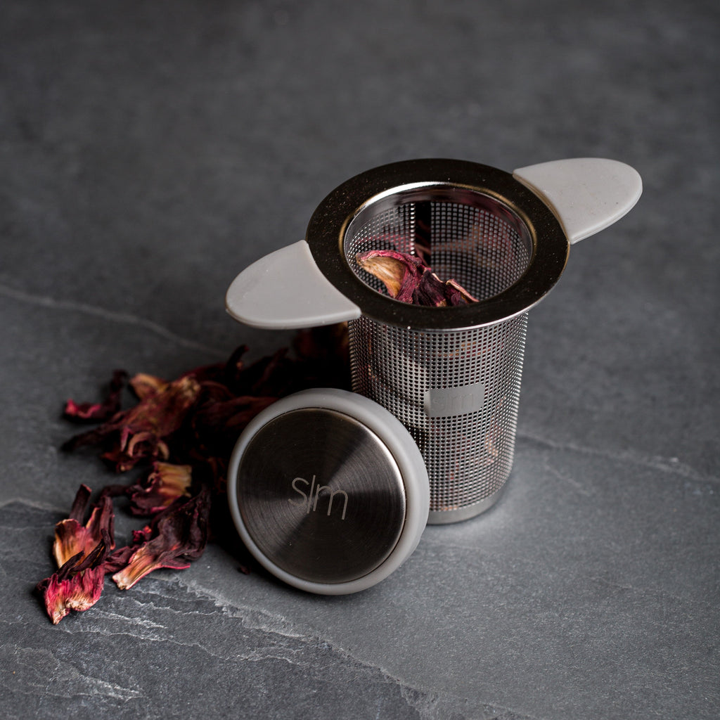 Dark gray textured surface with stainless steel and metallic elements, accented with deep burgundy tones