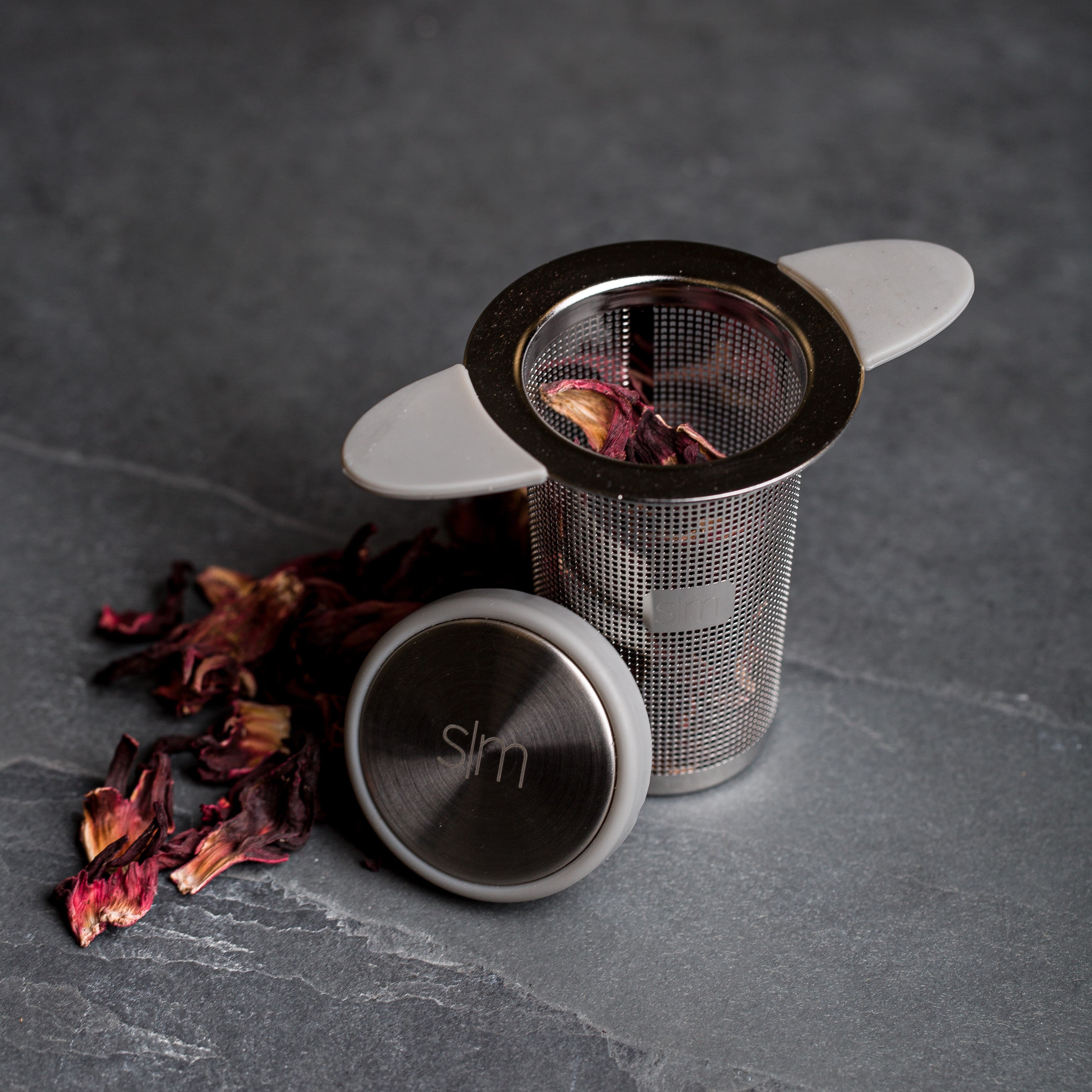 Dark gray textured surface with stainless steel and metallic elements, accented with deep burgundy tones