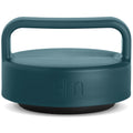 Muted teal jar lid with dark charcoal base against clean white background