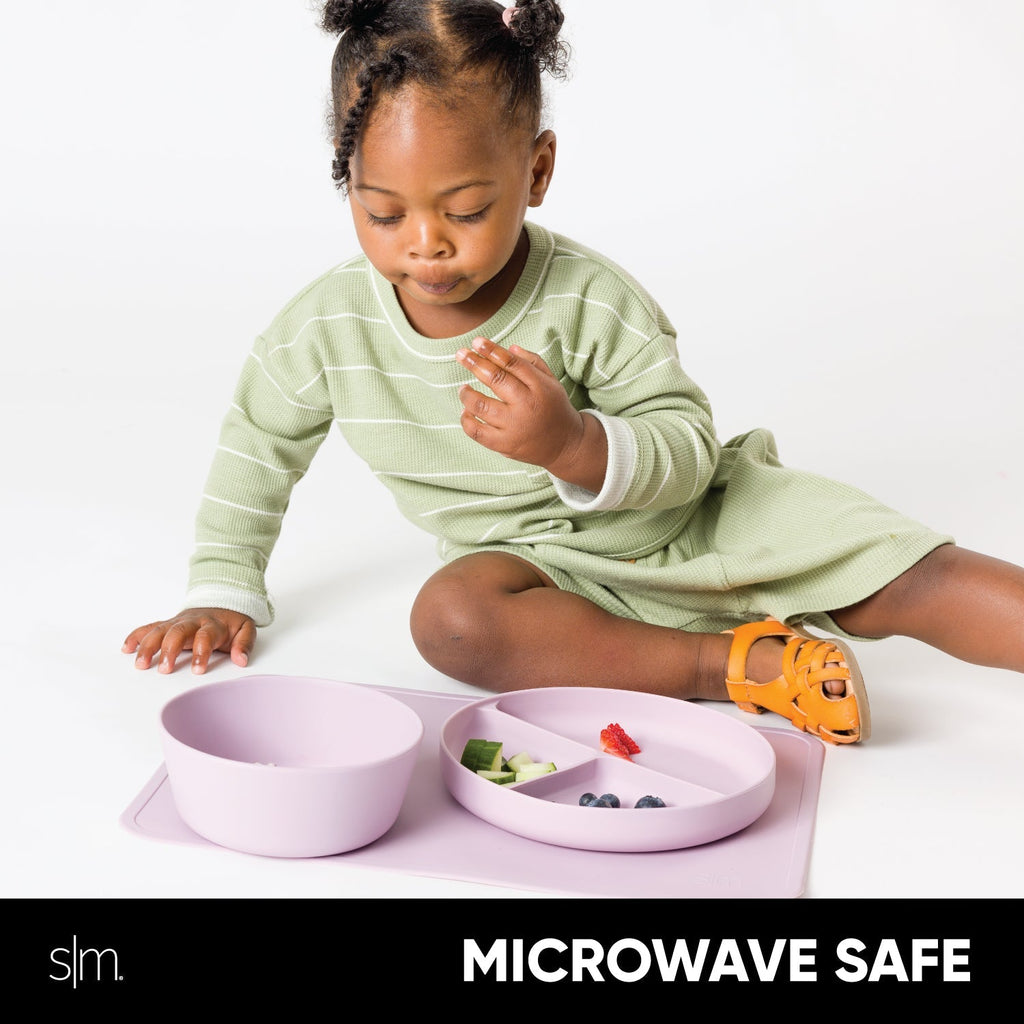 Pale blush pink silicone toddler dinnerware set with soft sage green and white striped long-sleeve shirt, microwave safe children's dishes