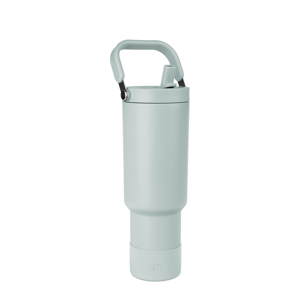 Sage green tumbler with black accents, featuring a modern minimalist design with soft muted tones and contemporary styling.