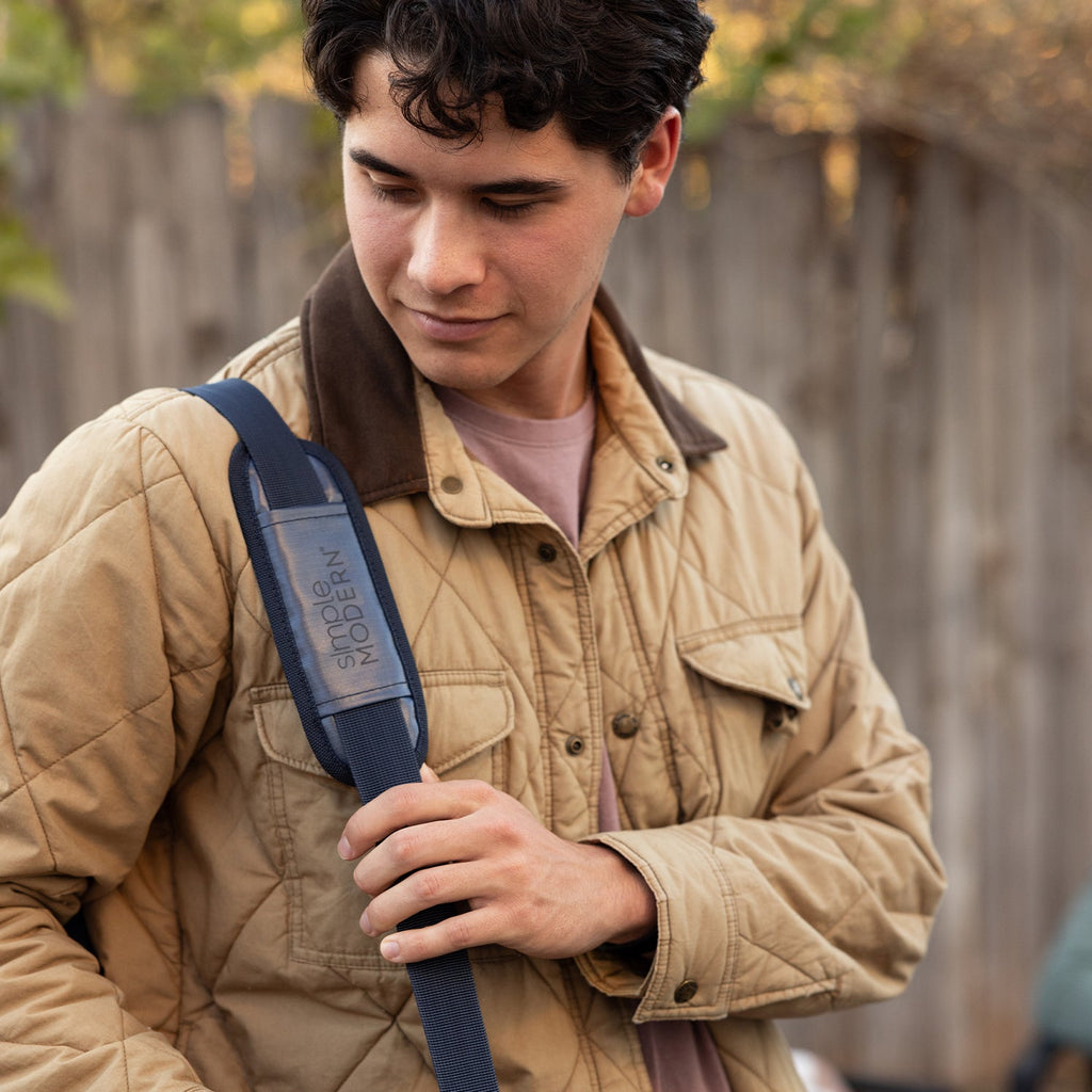 Person wearing tan quilted jacket with mauve accents against khaki and beige background, warm earthy tones throughout